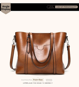 Front view of large capacity dark brown leather tote bag with handles and strap