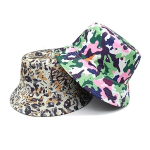 Detail showing leopard print and colorful camo patterns on cotton bucket hats