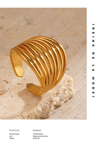 Detailed macro of golden multi-layered open ring on elegant textured stone background