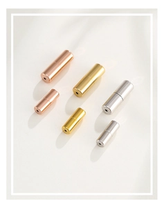Macro view of silver and 18K gold spiral clasps for pearl necklaces in multiple sizes