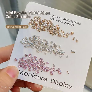 Mix of 50 multi-shaped nail art zircons in white, champagne, and pink on display card
