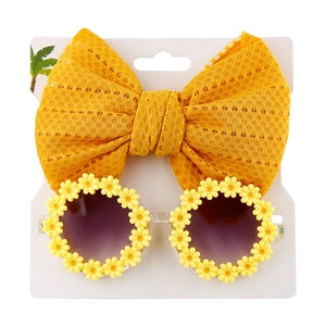 Detail of yellow daisy sunglasses and mesh bow headband set for kids and babies