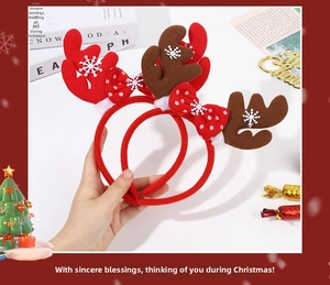 Detail of Christmas reindeer antler headbands with white snowflake prints and polka dot bows