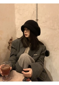 Close-up of black ribbed knit beanie paired with a dark grey oversized blazer