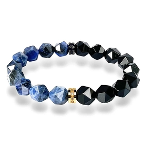 Detail of tiger eye and obsidian beaded bracelet with gold and black pavé zircon spacers
