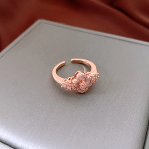 Detailed macro view of gold plated four-leaf clover ring with zircon and mother of pearl