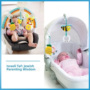 Stroller activity arch toy featuring colorful rattle plushies and teething rings in use