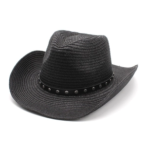 Detailed texture of black straw cowboy hat with silver rivets and leather band decoration