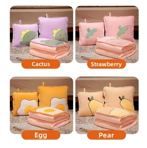 Close-up of four cartoon 2-in-1 pillow blankets featuring cactus, strawberry, egg, and pear