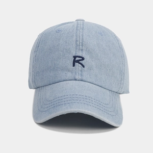 Macro view of blue denim baseball cap featuring high-quality R letter embroidery details