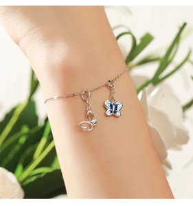 Close-up of S925 sterling silver bracelet with hollow and blue enamel butterfly charms