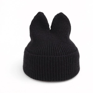 Detail of black cat ear knit beanie featuring thick ribbed texture and warm fabric
