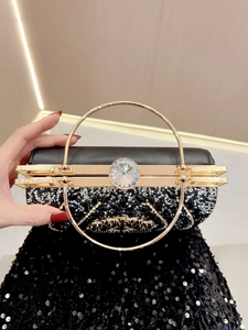 Elegant black evening clutch bag with sparkling rhinestones and gold circular handle