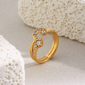 Close-up of 18K gold plated moon and star wave ring with crystals on white rock