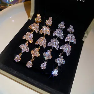 Sparkling silver leaf tassel earrings with crystal clusters in gold and silver finish