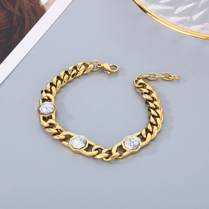 Detail of gold Cuban link bracelet with three hexagonal white marble stone inlays