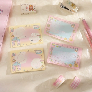 Detailed view of cute cartoon memo pads with aesthetic stationery on textured background