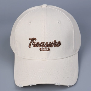 Close-up of beige cotton baseball cap featuring brown 3D embroidery and frayed edge detail