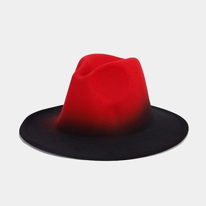 Detail of red and black gradient wool felt fedora hat with a wide brim and classic top crown