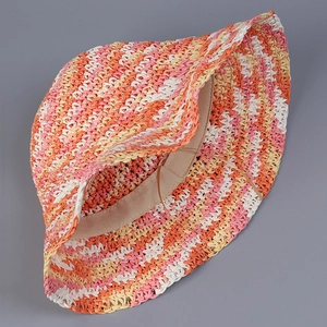 Detailed inner view of colorful hand-woven straw hat showing adjustable strap and texture