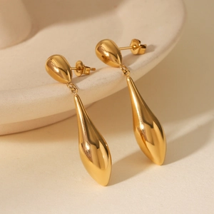 Detailed macro view of 18K gold plated stainless steel teardrop earrings with a mirror finish