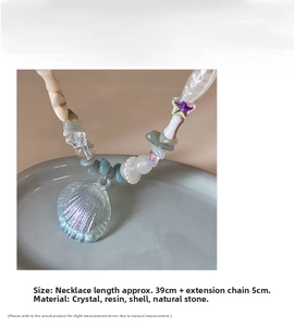 Macro shot of ocean style beaded necklace with shell pendant and colorful crystals