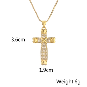 Detail view of 18K gold plated cross pendant with heart and white zircon stones