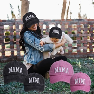 Outdoor shot of Mama and Mini baseball caps with 3D embroidery on black and pink cotton