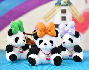 Three cute plush panda keychains with colorful oversized bows shown in a bright setting