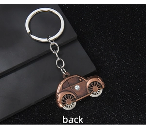 Rear view of bronze vintage car keychain with rhinestones and silver metal ring