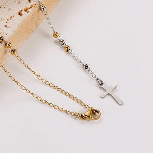 Vintage stainless steel cross necklace set with diamonds on minimalist beige stone base