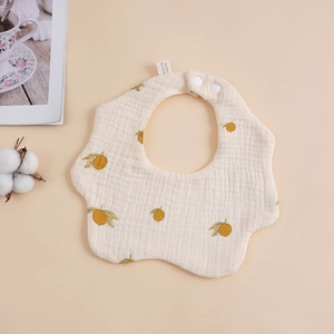 Detail of soft 6-layer cotton baby bib with lemon print and snap fasteners