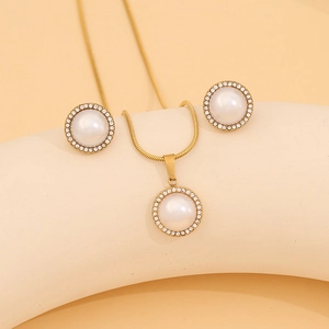 Detail of gold halo jewelry set featuring imitation pearls and sparkling crystal pavé