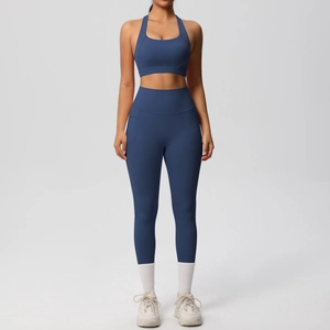 Detail view of high-waist navy yoga leggings with side pockets and matching sports bra