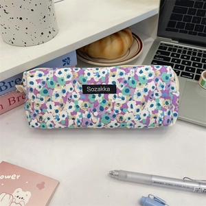 Detail of floral canvas pouch with Sozakka label, zipper closure, and vintage pattern