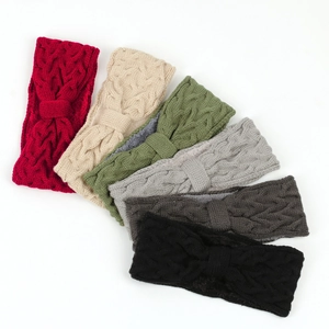 Winter knitted headbands in six colors with cable knit texture and bow accent on white background
