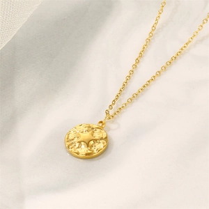 Gold plated stainless steel coin necklace with embossed star pendant on marble background
