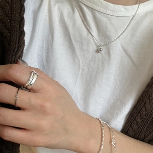 Minimalist 925 sterling silver beaded necklace with matching rings and bracelet on model