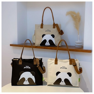 Detailed display of panda canvas tote bags in black, white, and khaki with brown straps
