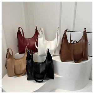 Collection of minimalist faux leather shoulder bags in five colors on a white pedestal