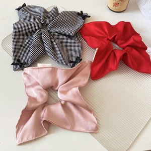 Close-up of assorted satin and cotton hair scrunchies with elegant bowknot detail