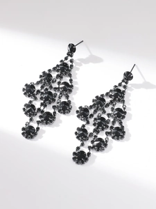 Close-up of elegant long black rhinestone tassel earrings with chandelier design
