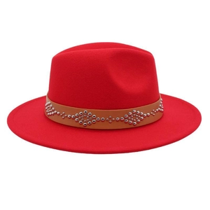 Close-up of red wool fedora featuring a brown leather band with silver metal rivets