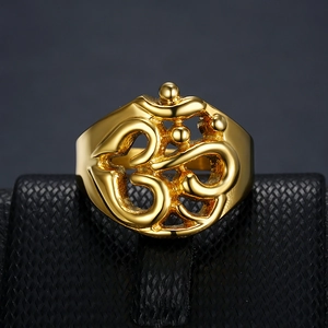 Golden punk ring with Om symbol cutout design on a black professional display base