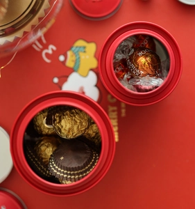 Close-up of a festive red tin canister filled with assorted premium chocolates