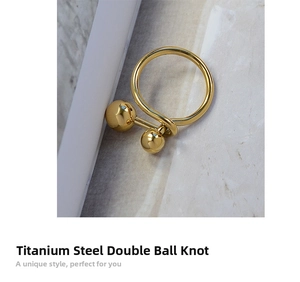 Detail shot of the gold-plated titanium steel ring with double ball knot design