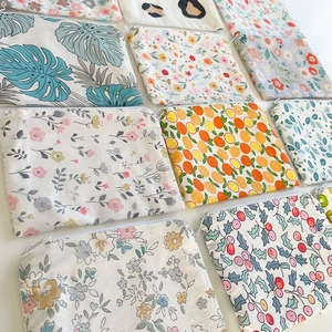 Close-up of assorted floral cotton canvas coin purses with zipper closure and varied prints