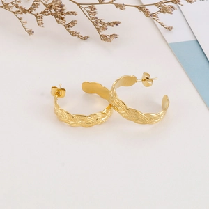 Detailed view of 18k gold plated stainless steel twisted texture C-shaped hoop earrings