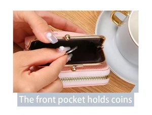 Front pocket of pink faux leather purse being used to store coins with metal clasp