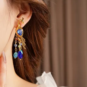 Vintage gold peacock dangle earrings with blue crystal drops and colorful beaded tassels